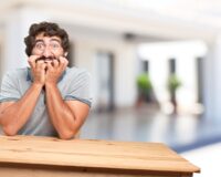 young-man-table-worried-expression