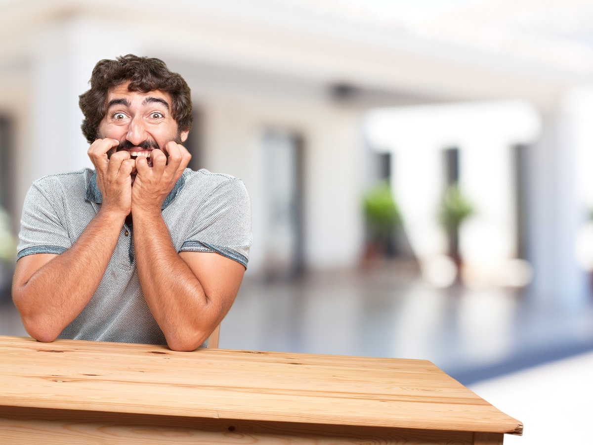 young-man-table-worried-expression